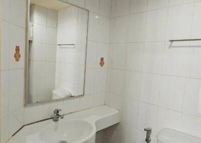 Clean and modern bathroom with white tiles and well-equipped amenities
