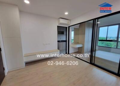 Spacious bedroom with modern design, large mirror wardrobe, and scenic window view