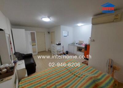 Compact bedroom with integrated living space featuring modern amenities