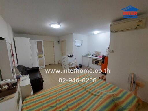 Compact bedroom with integrated living space featuring modern amenities