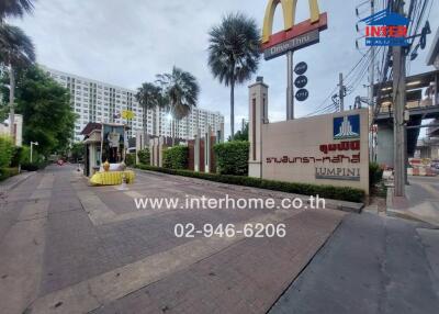 Exterior view of a residential building with adjacent fast food restaurant