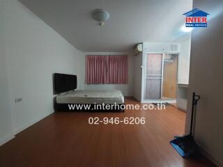 Spacious bedroom with wooden flooring and inbuilt wardrobe