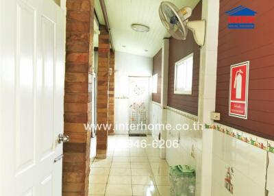 Bright and spacious corridor with decorative tile flooring and access to multiple rooms