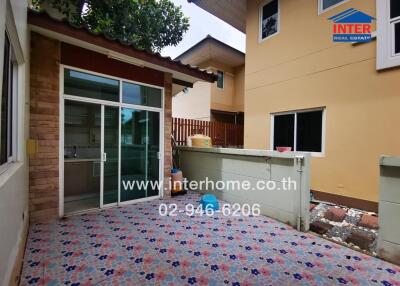Spacious patio area with sliding doors leading to the kitchen