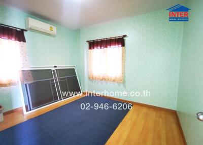 Spacious bedroom with air conditioning and hardwood flooring