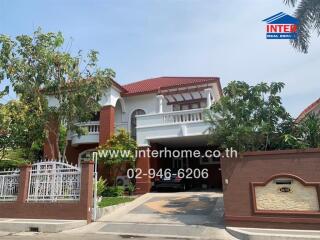 Exterior view of a two-story residential house with a carport