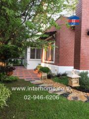Charming brick house with a landscaped front yard and pathway