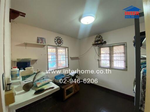 Spacious well-lit kitchen with large windows and plenty of counter space