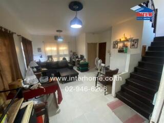 Spacious living room interior with stairs and modern furniture