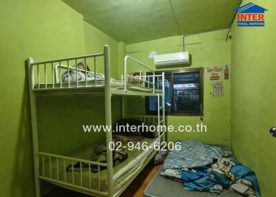 Compact bedroom with bunk beds and air conditioning unit