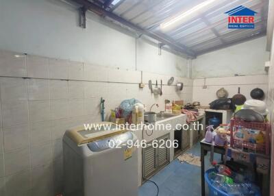 Cluttered residential kitchen with appliances and utensils