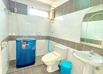 Compact bathroom with modern appliances and tiled flooring