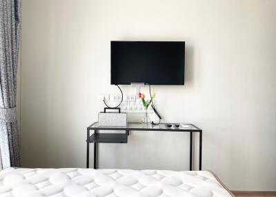 Modern bedroom with wall-mounted television and minimalist design