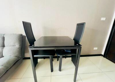Modern dining table with chairs in a contemporary room with tiled flooring