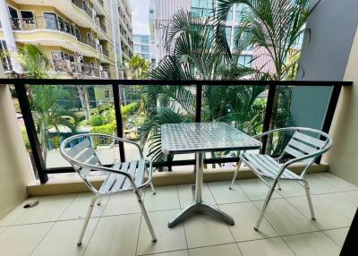 Spacious balcony with garden view and a dining set