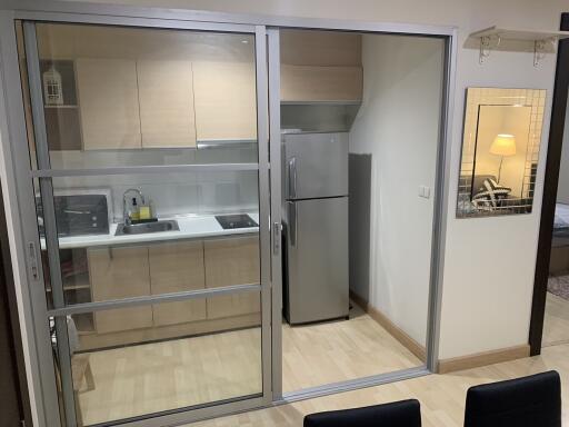 Modern kitchen with a view into the living room through sliding glass doors