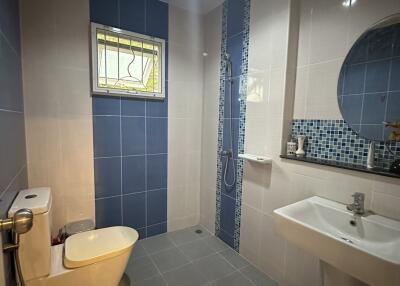 Modern bathroom with blue tiles and natural light