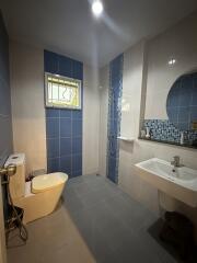Modern bathroom with blue tiles and natural light