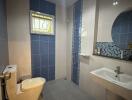 Modern bathroom with blue tiles and natural light