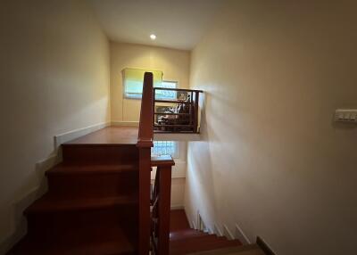 Interior view of a wooden staircase leading to an upper level with warm lighting