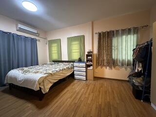 Spacious and well-lit bedroom interior with modern furnishings.