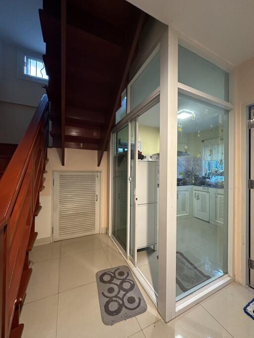 Spacious hallway with staircase and reflective sliding glass doors