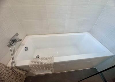 Modern white bathroom with a clean bathtub and shower