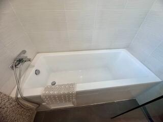 Modern white bathroom with a clean bathtub and shower