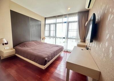 Well-lit spacious bedroom with modern amenities
