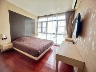 Well-lit spacious bedroom with modern amenities