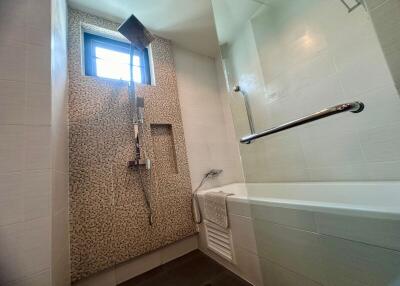 Modern bathroom with bathtub and decorative tiling