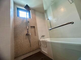 Modern bathroom with bathtub and decorative tiling