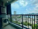 Spacious balcony with panoramic city view and washing machine