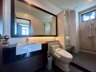 Modern bathroom with sleek fixtures and ample lighting