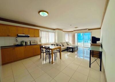 Spacious combined kitchen and living room with modern appliances and ample seating