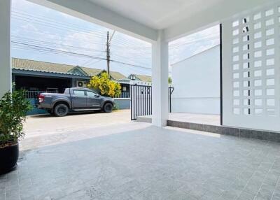 Spacious carport with sleek tiling and ample parking