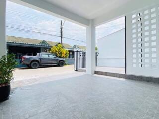 Spacious carport with sleek tiling and ample parking