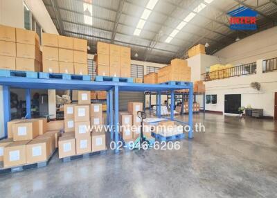 Spacious Warehouse with Blue Storage Racks and Cardboard Boxes