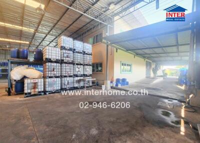 Spacious warehouse interior with stacked goods and ample lighting