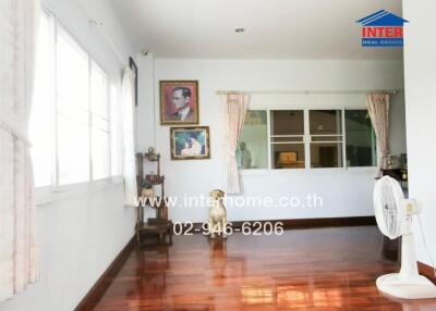 Spacious living room with natural light and hardwood floors