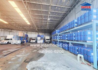 Spacious warehouse interior with storage racks and vehicles