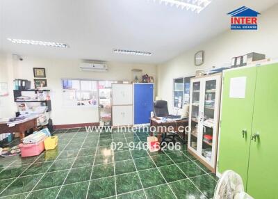 Spacious office interior with green tile flooring and organized workspace