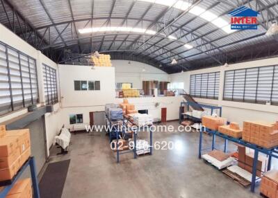 Spacious warehouse interior with storage and office spaces