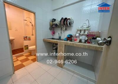 Compact bathroom with various personal items and visible toilet
