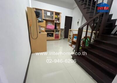 Spacious living room with staircase and storage unit