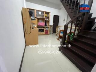 Spacious living room with staircase and storage unit