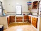 Spacious kitchen with wooden cabinets and tiled flooring