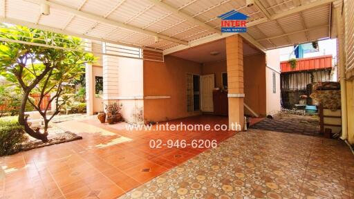 Spacious and well-shaded patio area with plants and terra cotta tiles