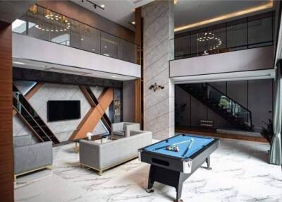 Luxurious modern living room with pool table and elegant decor
