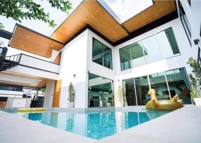 Modern house with swimming pool and floating inflatable toy